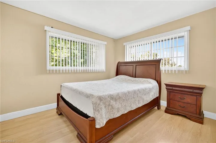Bedroom with light wood-style flooring and multiple windows