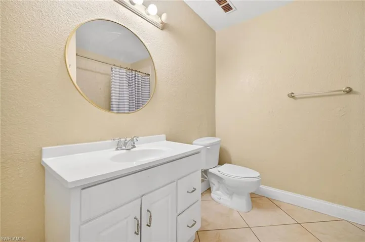 Bathroom with vanity and tile patterned flooring