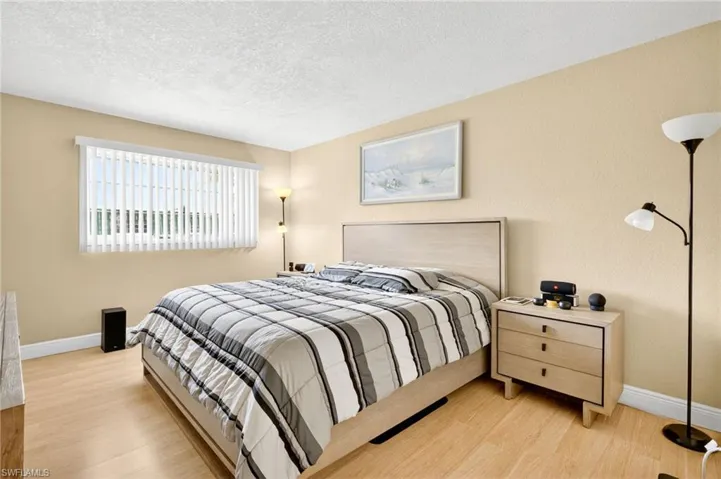 Bedroom featuring wood finished floors and a textured ceiling