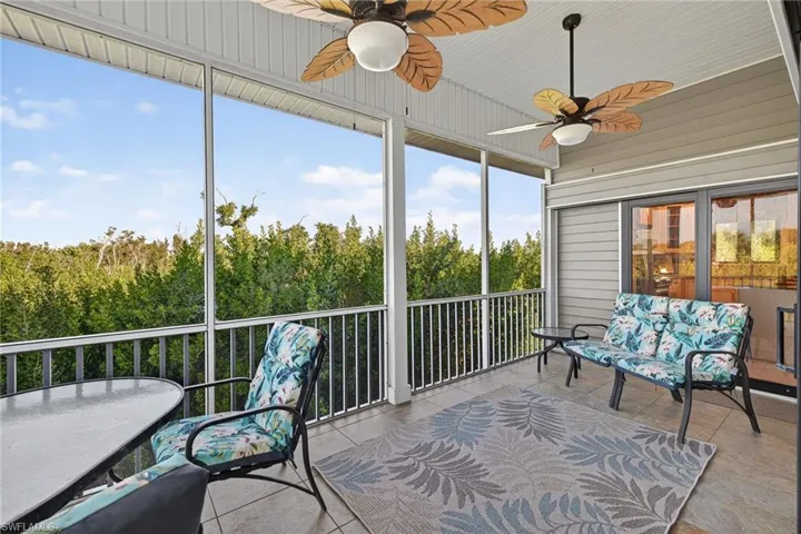 Sunroom featuring a ceiling fan