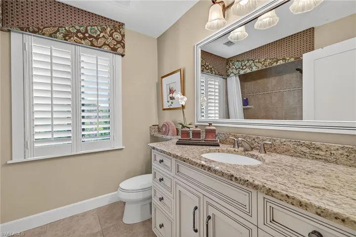 Bathroom featuring vanity, a shower with curtain, and light tile patterned flooring
