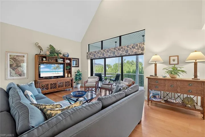 Living room featuring high vaulted ceiling and light wood-type flooring
