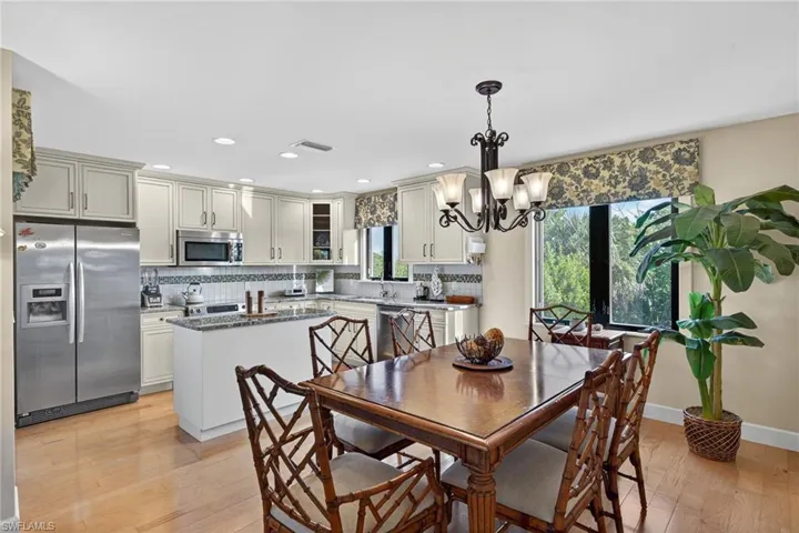 Dining space with a chandelier, light wood-type flooring, recessed lighting, and plenty of natural light