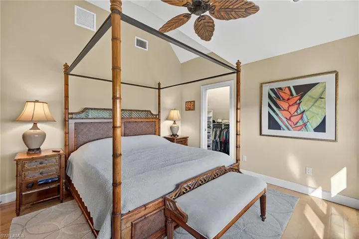 Bedroom featuring a spacious closet, ceiling fan, and lofted ceiling