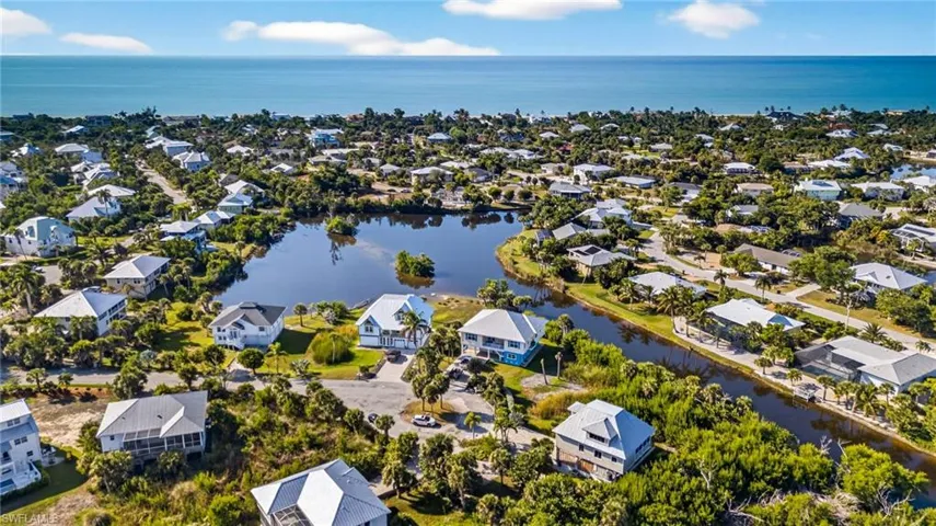 Aerial perspective of suburban area featuring a large body of water