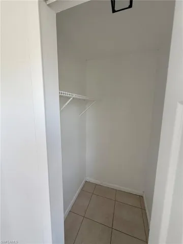 Spacious closet with light tile patterned flooring
