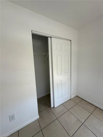 Unfurnished bedroom featuring a closet and light tile patterned floors