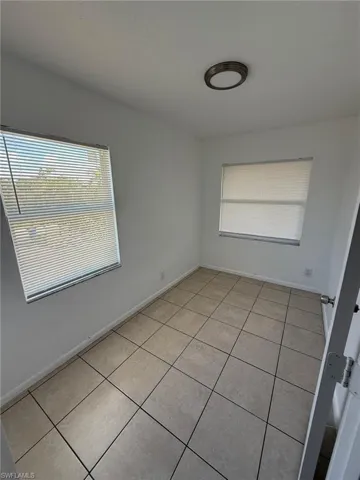 Spare room featuring healthy amount of natural light and light tile patterned floors