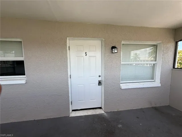 Doorway to property with stucco siding