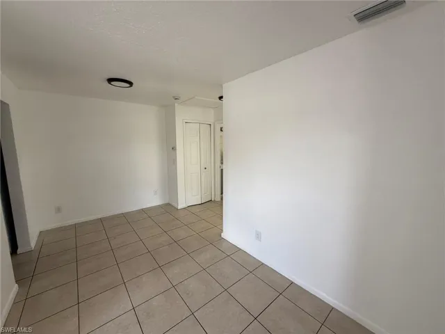 Unfurnished room with light tile patterned floors and a textured ceiling