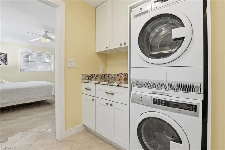 The full size laundry in the primary suite includes storage and counter space for folding, no need to use the common laundry