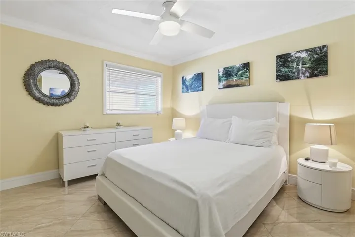 Guest bedroom located across the hall from the guest bathroom features space and natural light