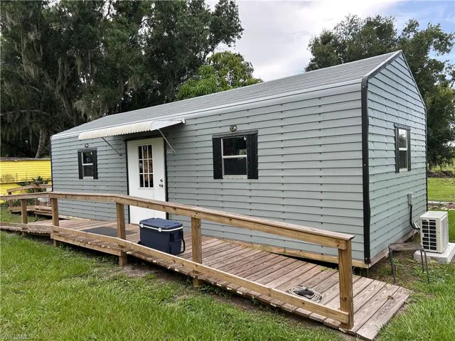 Back of house with a wooden deck