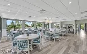 Clubhouse Dining area featuring wood-type flooring and a healthy amount of sunlight