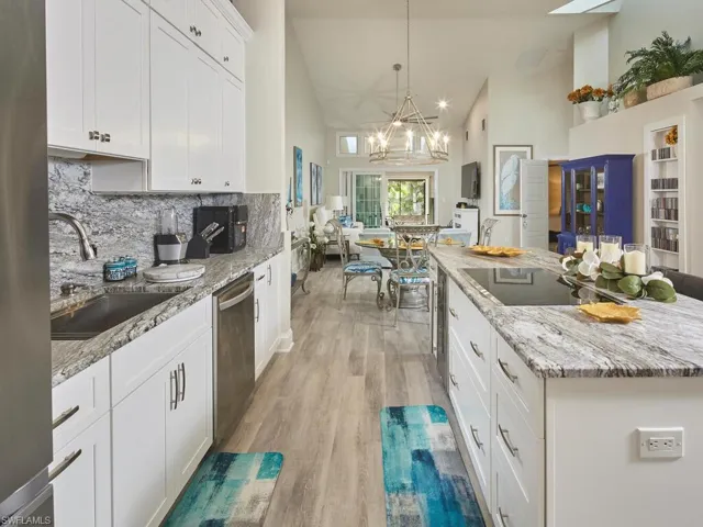 Kitchen with white black electric cooktop, and winecooler built in