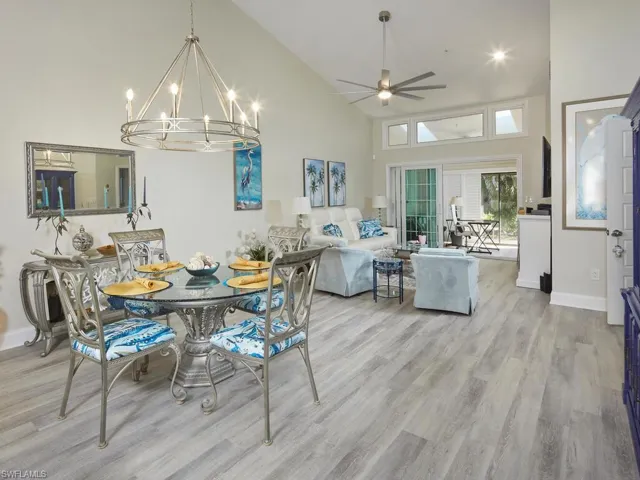 Dining area open concept layout into bright Living room w/skylight and high vaulted ceiling