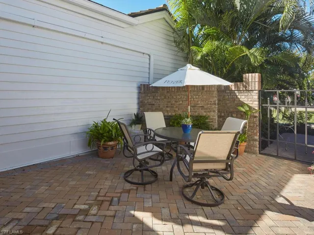 View of front courtyard patio behind gate at private entrance
