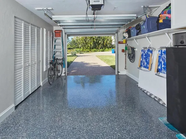 Garage featuring a finished epoxy flake flooring, garage door opener