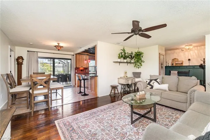 Living area with wood-style flooring, and ceiling fan