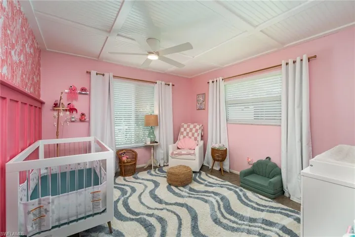 Bedroom 3 featuring washer / clothes dryer, a nursery area, a ceiling fan, and baseboards