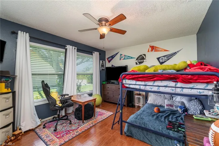 Bedroom 2 with wood finished floors, and a ceiling fan