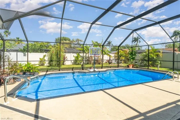 View of pool featuring a lanai, a patio, and a fenced backyard