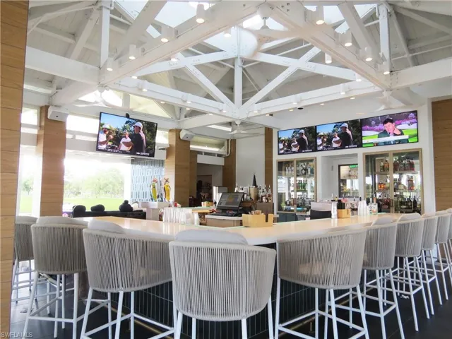 Dine at Fiddlers Creek Clubhouse over the pool and lake