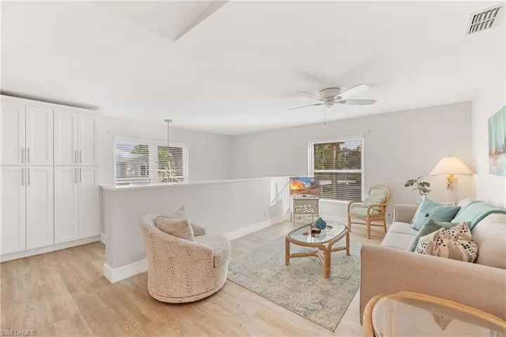 Bonus room area featuring light hardwood / wood-style floors and ceiling fan