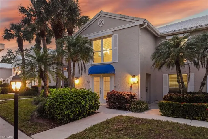 View of front facade at twilight featuring french doors
