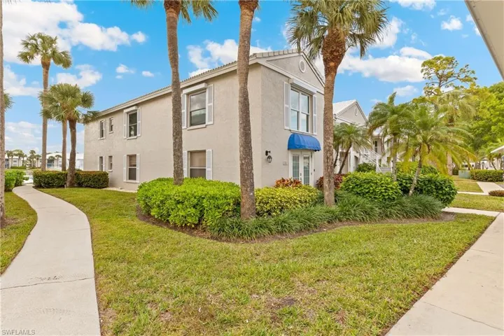 View of side of property featuring a lawn