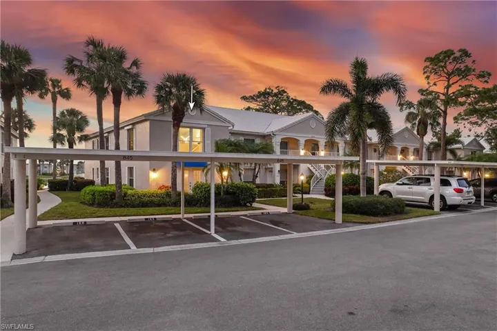 View of outdoor building and carport area at dusk