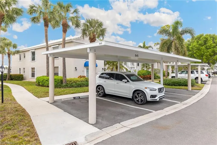 View of parking with a carport. This unit parking spot is on the end.