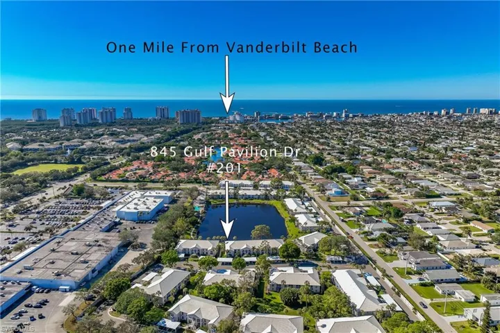 Birds eye view of property with a water view showing distance to the beach