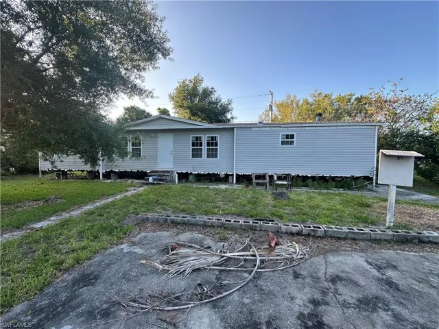 Back of property featuring a lawn