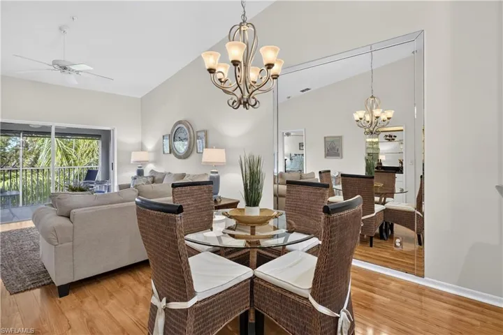 Vaulted ceilings, wood-finish flooring, and a decorative chandelier