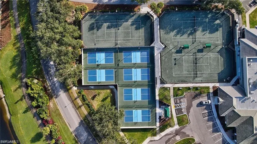 Tennis courts and pickleball courts with adjacent parking and surrounding landscaping