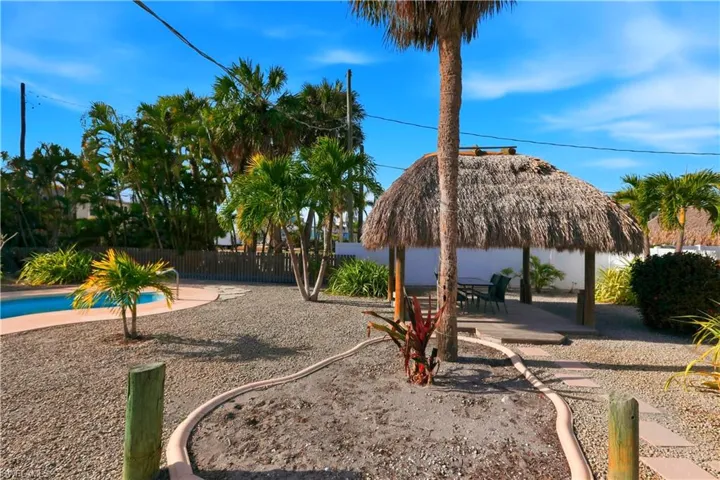 View of property's community featuring a patio area, a fenced backyard, a swimming pool, and a gazebo