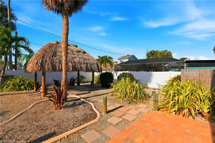 Fenced backyard featuring a patio, a sunroom, and a gazebo