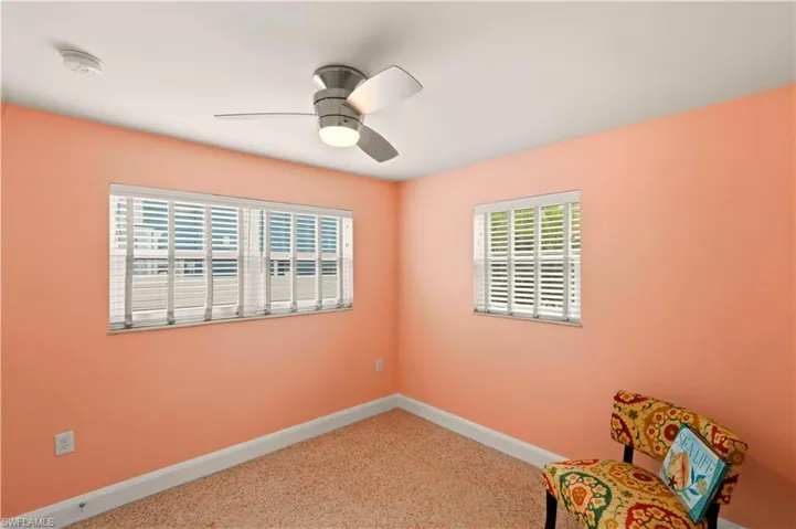 Unfurnished room with baseboards and ceiling fan