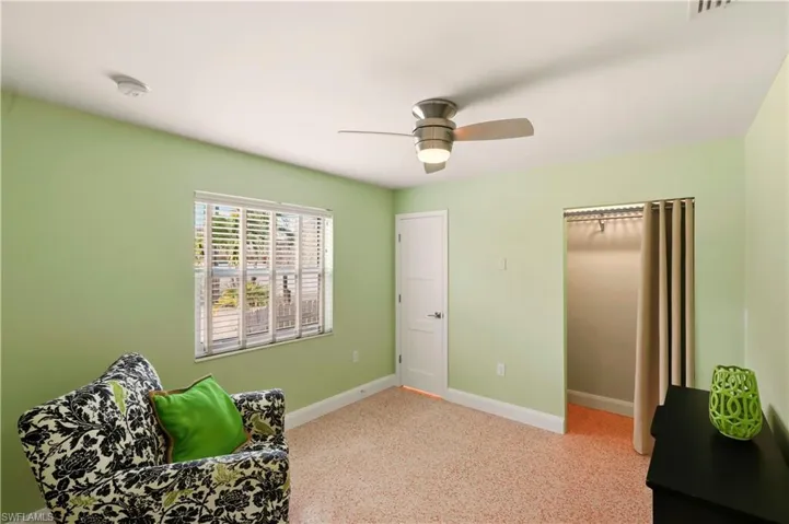Sitting room with baseboards and ceiling fan