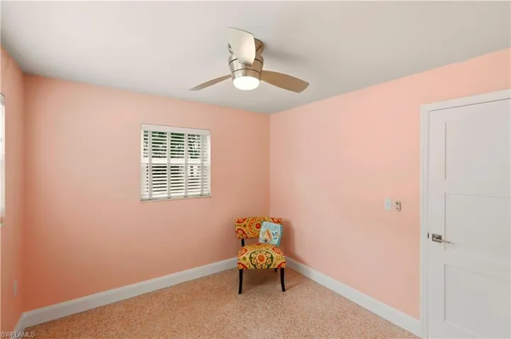 Unfurnished room with baseboards and a ceiling fan