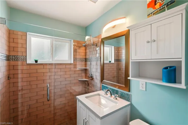 Full bath featuring vanity and a shower stall