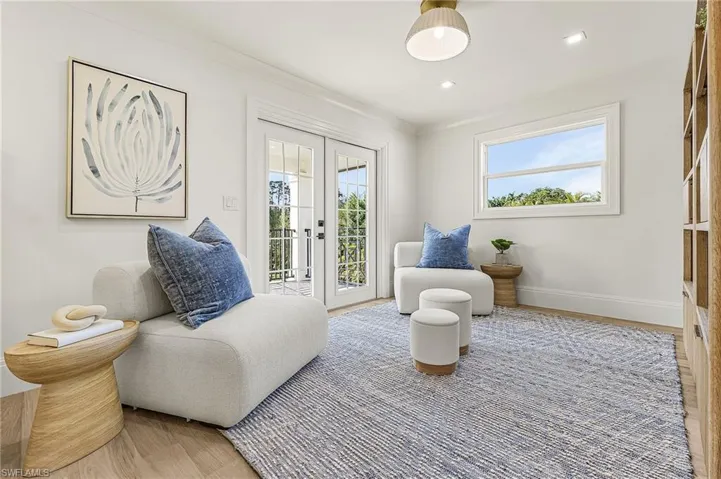 Living area featuring french doors, plenty of natural light, wood finished floors, and recessed lighting