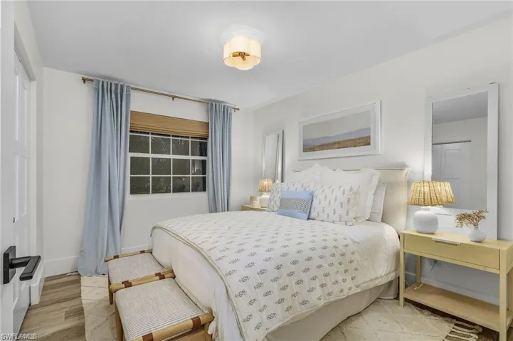 Bedroom featuring baseboards and wood finished floors