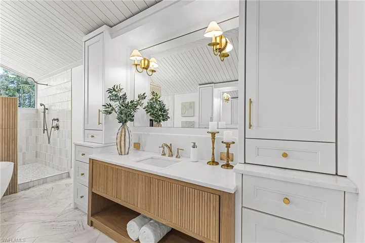 Full bathroom with vanity, light marble finish floors, lofted ceiling, a walk in shower, and wooden ceiling