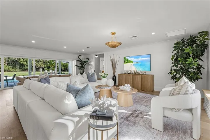 Living room featuring light wood finished floors and recessed lighting