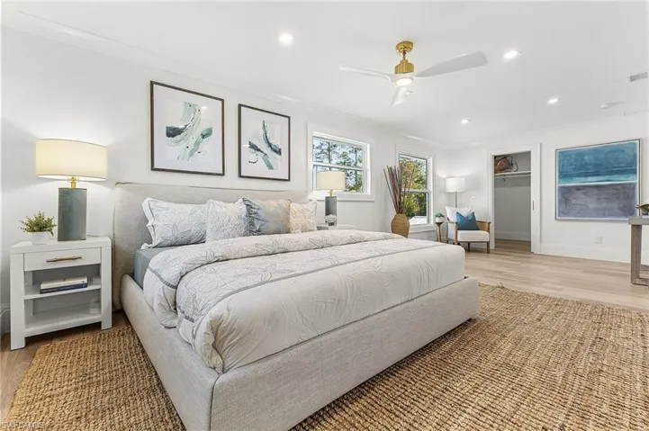 Bedroom featuring light wood-style flooring, ceiling fan, recessed lighting, and ornamental molding