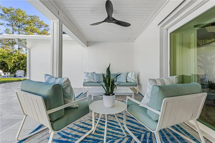 View of patio with a ceiling fan and an outdoor hangout area