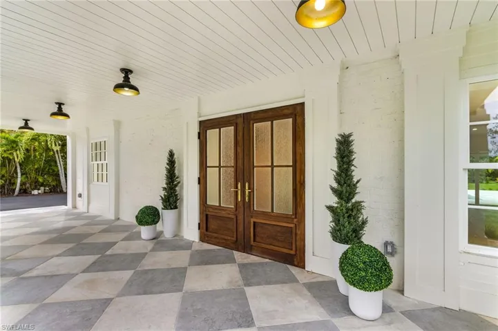 Doorway to property with french doors and brick siding