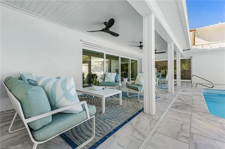 View of patio / terrace featuring an outdoor pool, a ceiling fan, and an outdoor living space